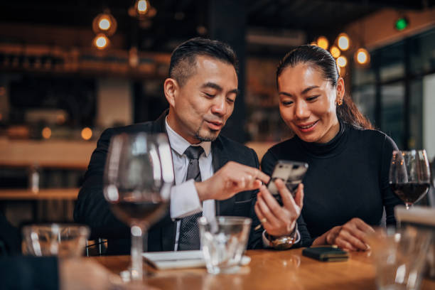 istock Gentleman and lady using smart phone in restaurant 1166617241