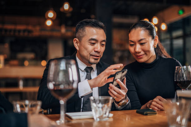 istock Gentleman and lady using smart phone in restaurant 1166617275