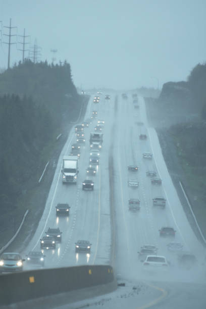 istock Vehicles with Headlights on at a Busy Highway During a Rainstorm 1166618449