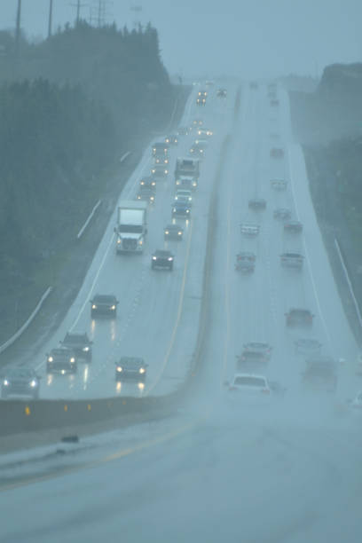 istock Vehicles with Headlights on at a Busy Highway During a Rainstorm 1166618792