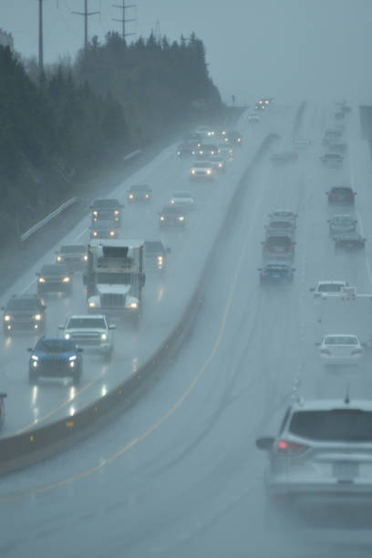 istock Vehicles with Headlights on at a Busy Highway During a Rainstorm 1166619032