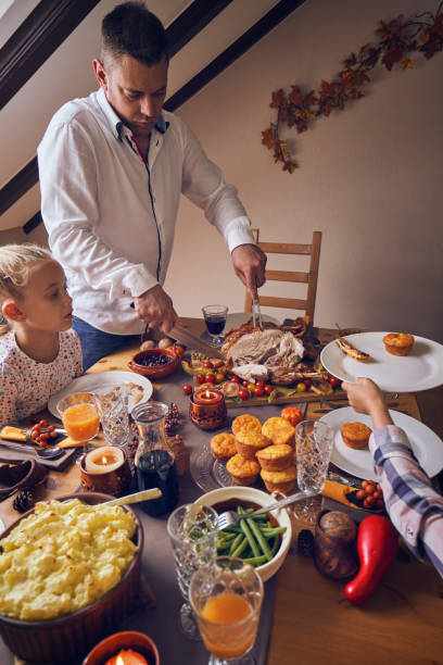 istock Family Having Traditional Holiday Stuffed Turkey Dinner 1166620814