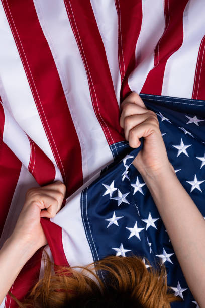 istock Woman hands pull USA United States flag 1166622131