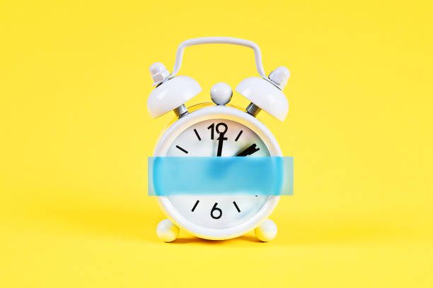 istock White alarm clock yellow pastel background. Blank sticky note on clock. Space copy. Minimal concept. 1166622186