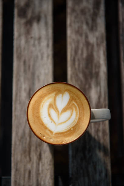 istock Heart shape coffee art in white cup on wooden table 1166622205