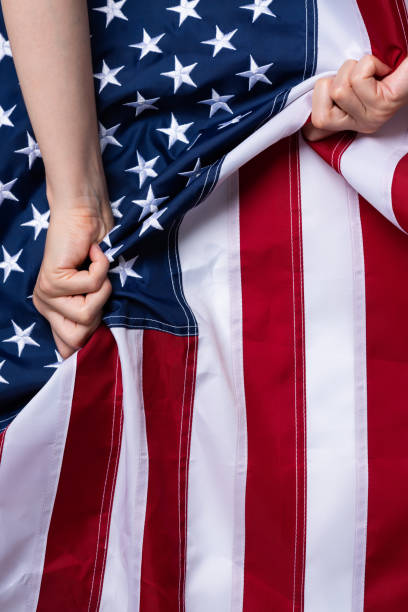 istock Woman hands pull USA american flag 1166622775