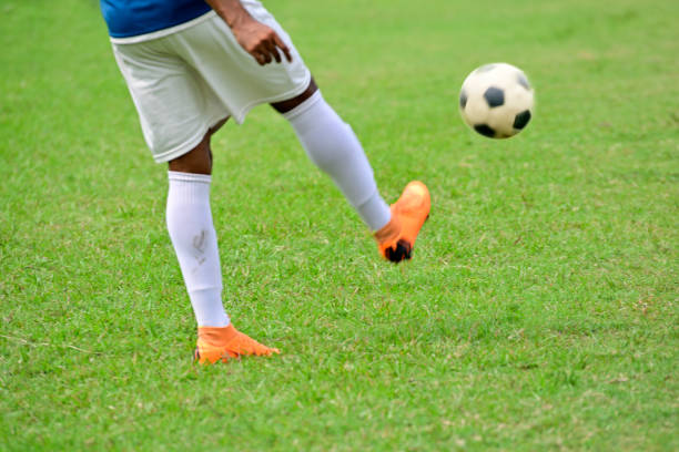 istock Boy kick soccer ball 1166622846