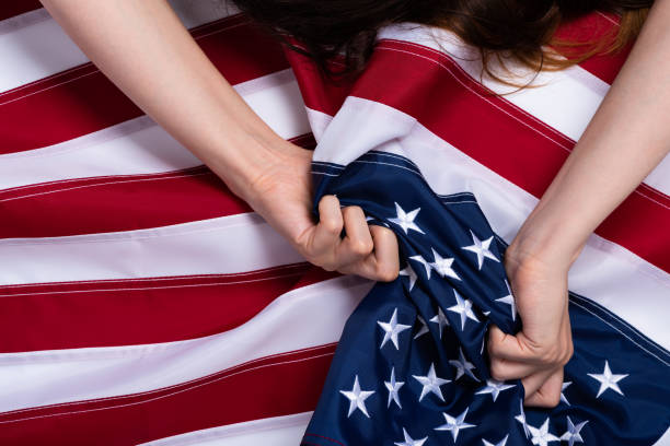 istock Young woman hands pulling USA american flag concept 1166622939