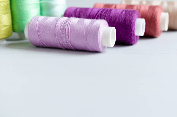istock Multi-colored spools of sewing threads close-up. Craft and hobby concept. 1166623658