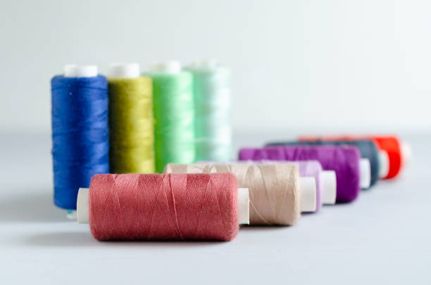 istock Multi-colored spools of sewing threads close-up. Craft and hobby concept. 1166623659