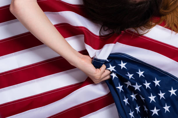 istock Young woman hand pulling USA american flag 1166624027