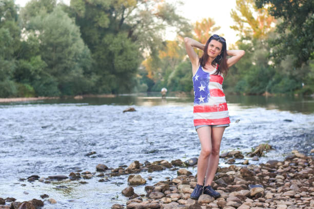 istock Beautiful middle aged woman on river coast 1166624476