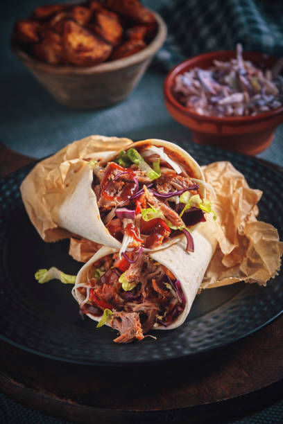 istock Pulled Pork Wrap Sandwich with Tomato, Salad and Chili 1166624547