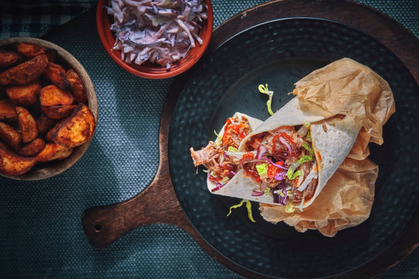 istock Pulled Pork Wrap Sandwich with Tomato, Salad and Chili 1166624589