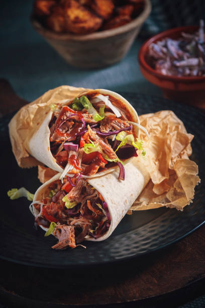istock Pulled Pork Wrap Sandwich with Tomato, Salad and Chili 1166624594