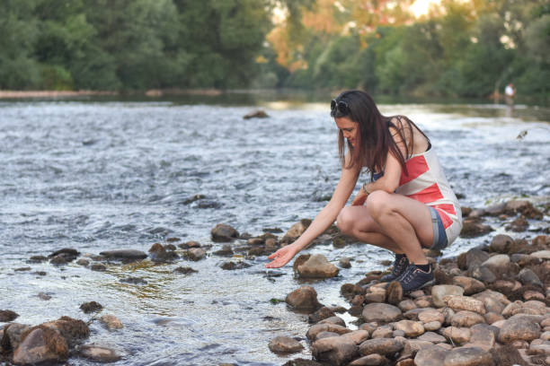 istock Beautiful middle aged woman on river coast 1166624603