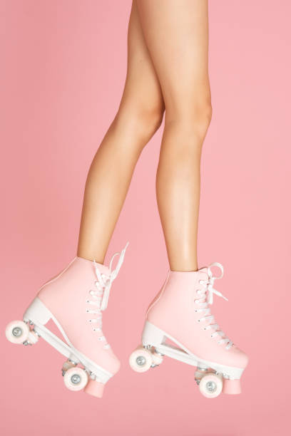 istock Pink roller skates on the legs. Activity can be fun! 1166624778