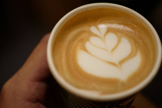 Coffee with froth art in paper cup