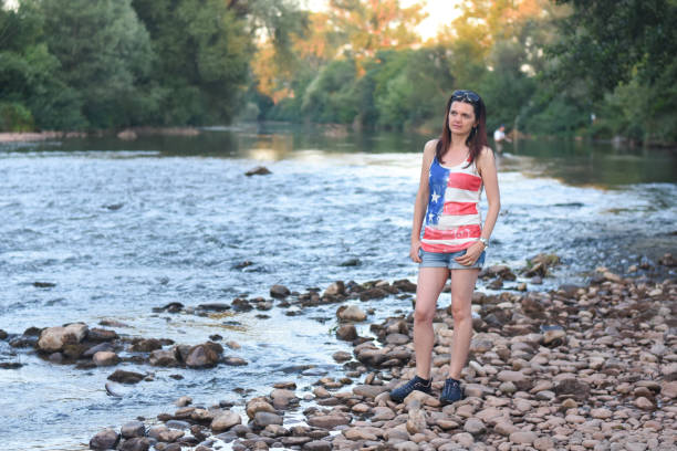 istock Beautiful middle aged woman on river coast 1166625330