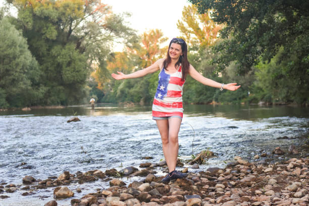 istock Beautiful middle aged woman on river coast 1166625940