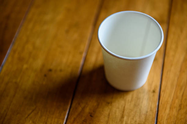 istock White paper cup on varnished wooden table 1166626279