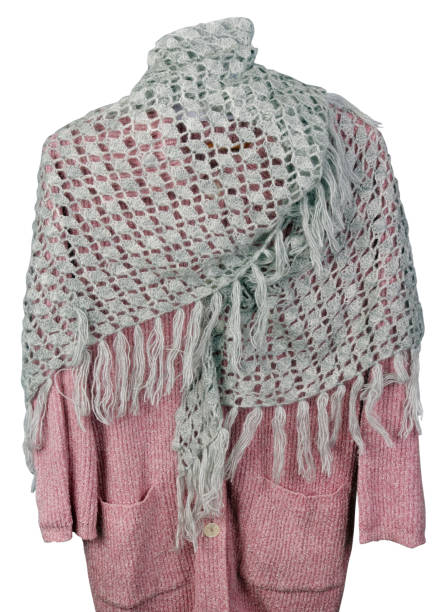 istock Homemade knitted warm gray triangular soft  women's  scarf hanging on a pink sweater  isolated 1166626665