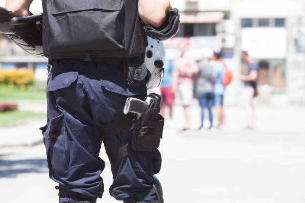 istock Police officer on duty, blurred people in the background 1166627207