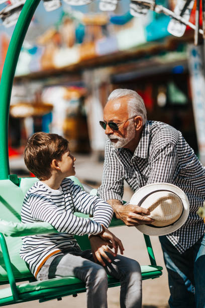 istock Grandfather and grandson amusement park fun 1166630002