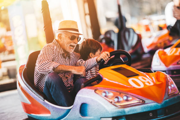 grandfather and grandson amusement park fun - youth and age imagens e fotografias de stock