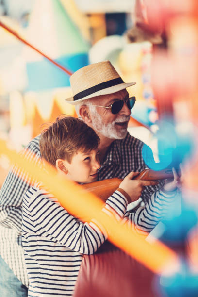 istock Grandfather and grandson amusement park fun 1166630684