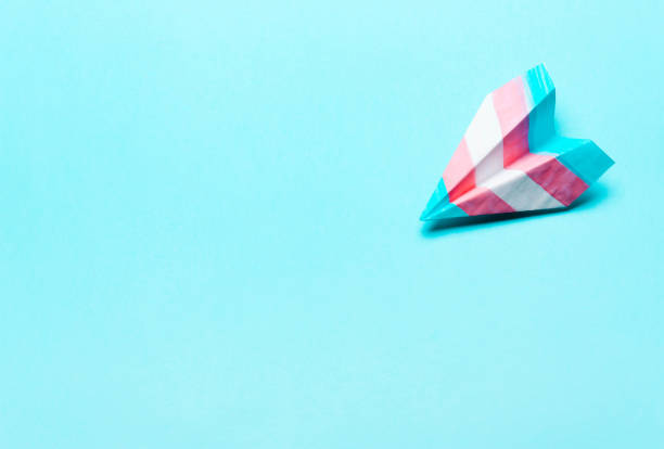 istock Paper airplane in transgender flag 1166631020