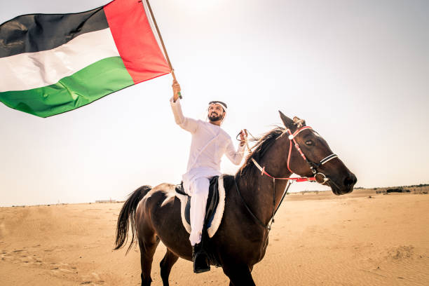 istock Arabian man with horse in the desert 1166635115