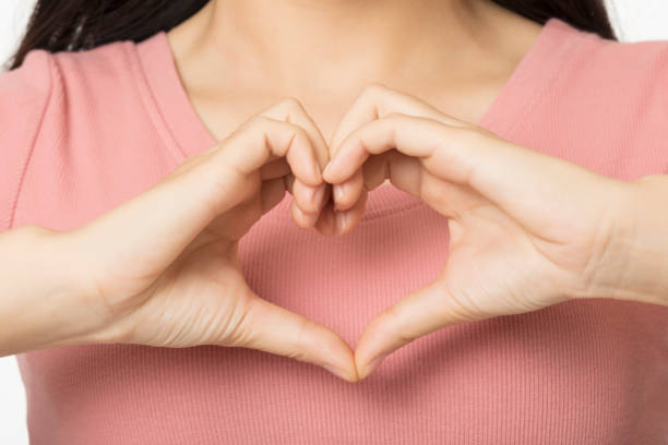 istock Asian woman making a heart shape using her hands 1166635208