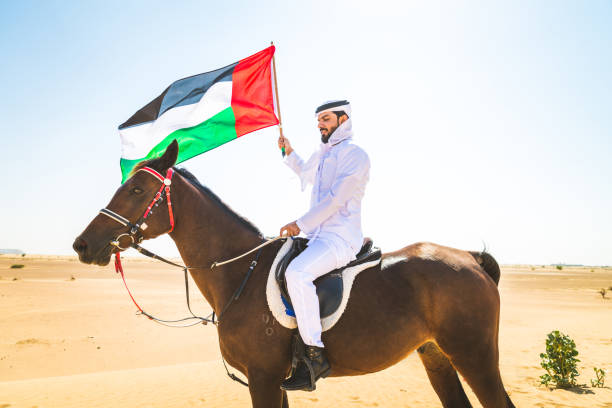 istock Arabian man with horse in the desert 1166635942