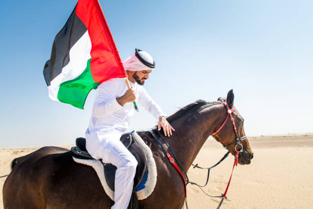 istock Arabian man with horse in the desert 1166635997