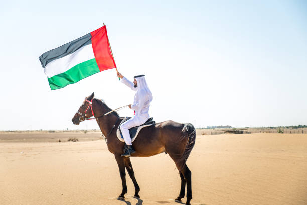 istock Arabian man with horse in the desert 1166636015