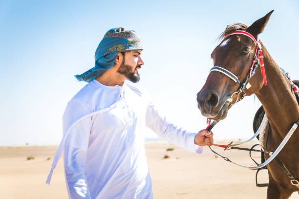 istock Arabian man with horse in the desert 1166636102