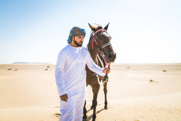 istock Arabian man with horse in the desert 1166636107