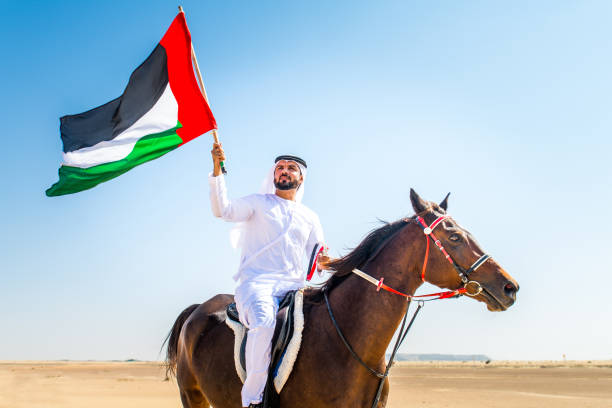 istock Arabian man with horse in the desert 1166636353