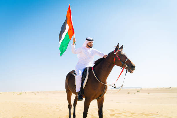 istock Arabian man with horse in the desert 1166636360