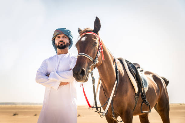 istock Arabian man with horse in the desert 1166636373
