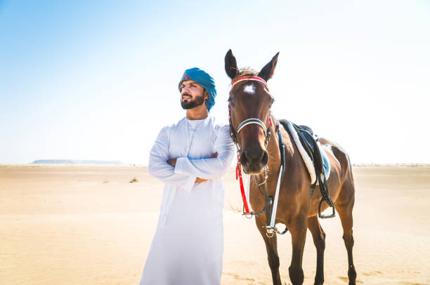 istock Arabian man with horse in the desert 1166636532