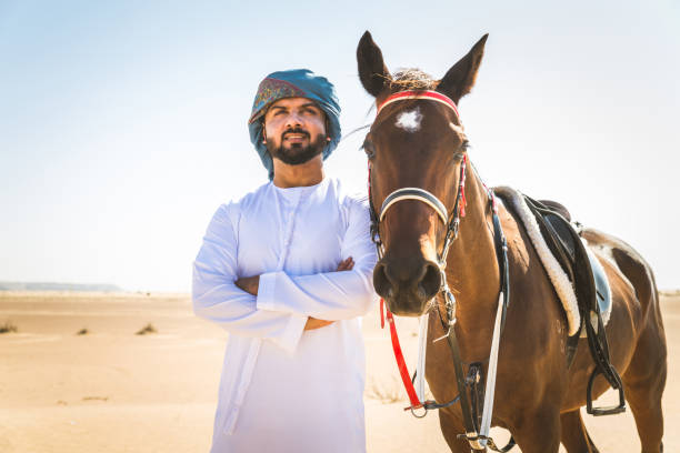 istock Arabian man with horse in the desert 1166636672