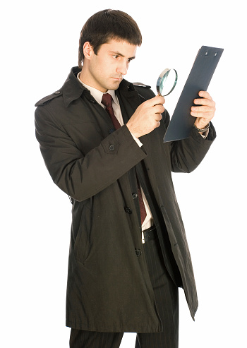 Detective with magnifying glass analyzing document, isolated on white background.