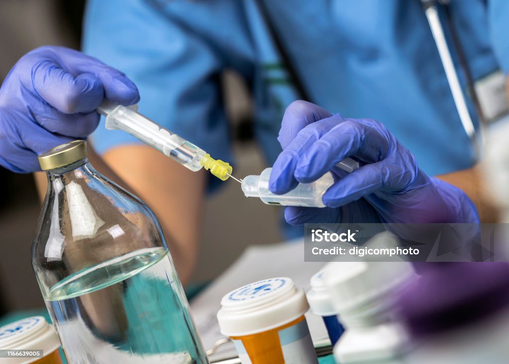 Nurse preparing medication for parenteral nutrition in a hospital, conceptual image Food and Drink Stock Photo