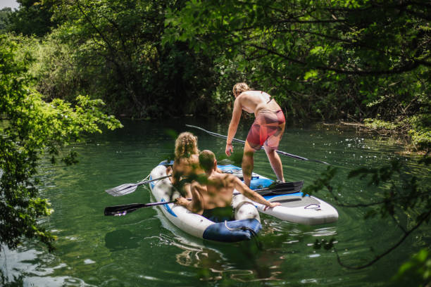 istock Expert kayaking couple helping out a new member 1166639284