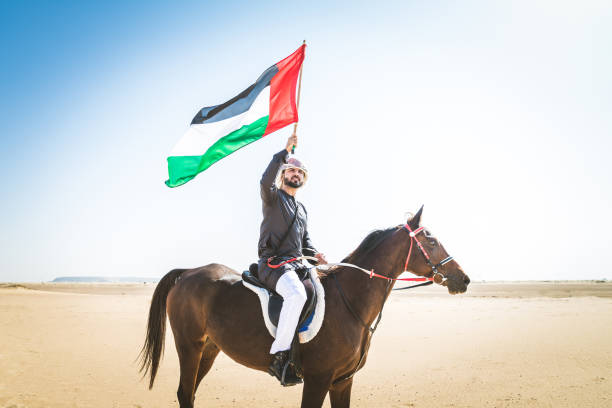 istock Arabian man with horse in the desert 1166639343