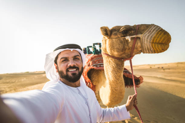 istock Arabian man with camel in the desert 1166639774