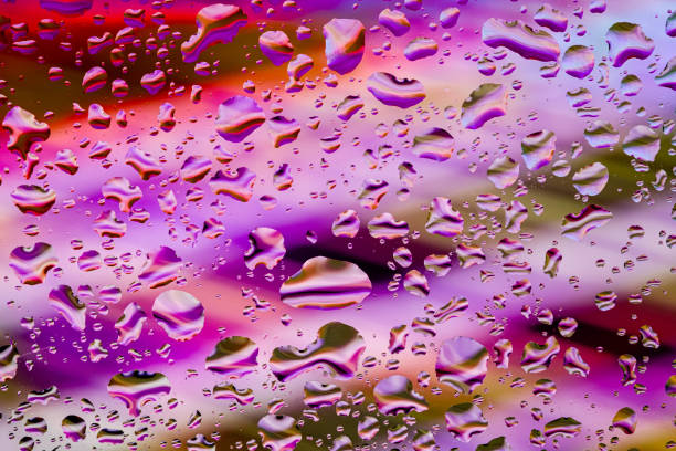 istock Neon lights behind water drops close up 1166640385