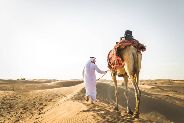 istock Arabian man with camel in the desert 1166640441